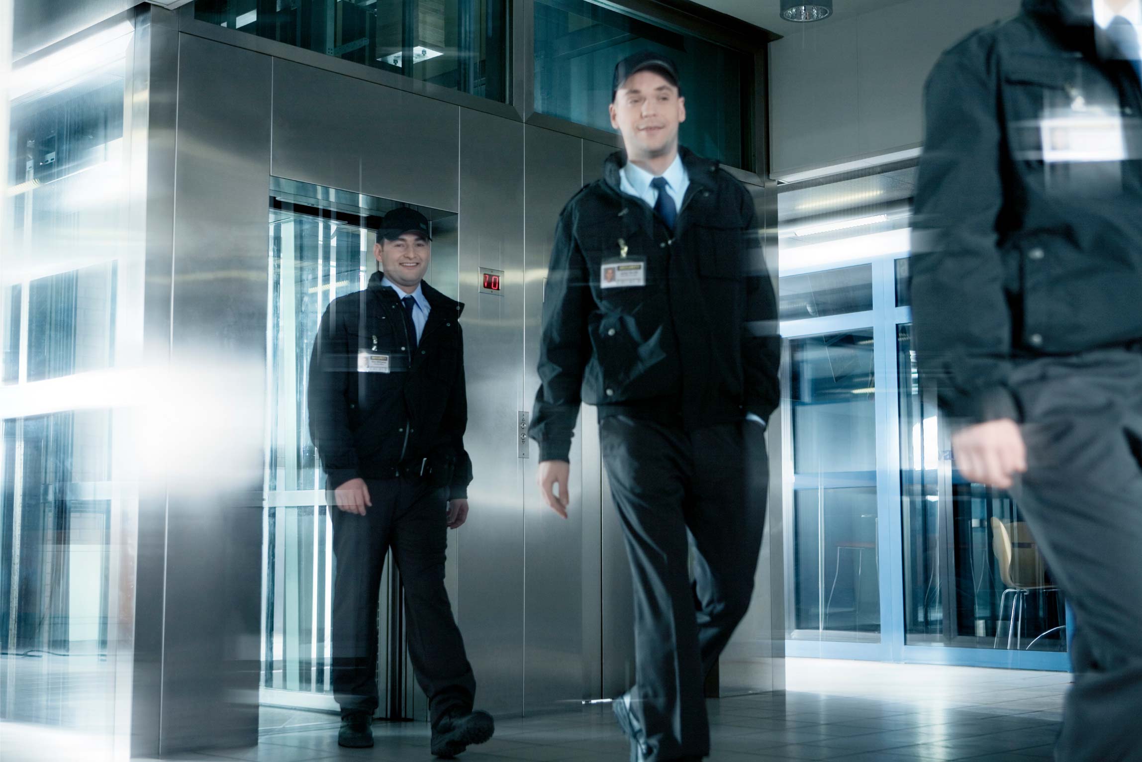 three security officers in black uniforms