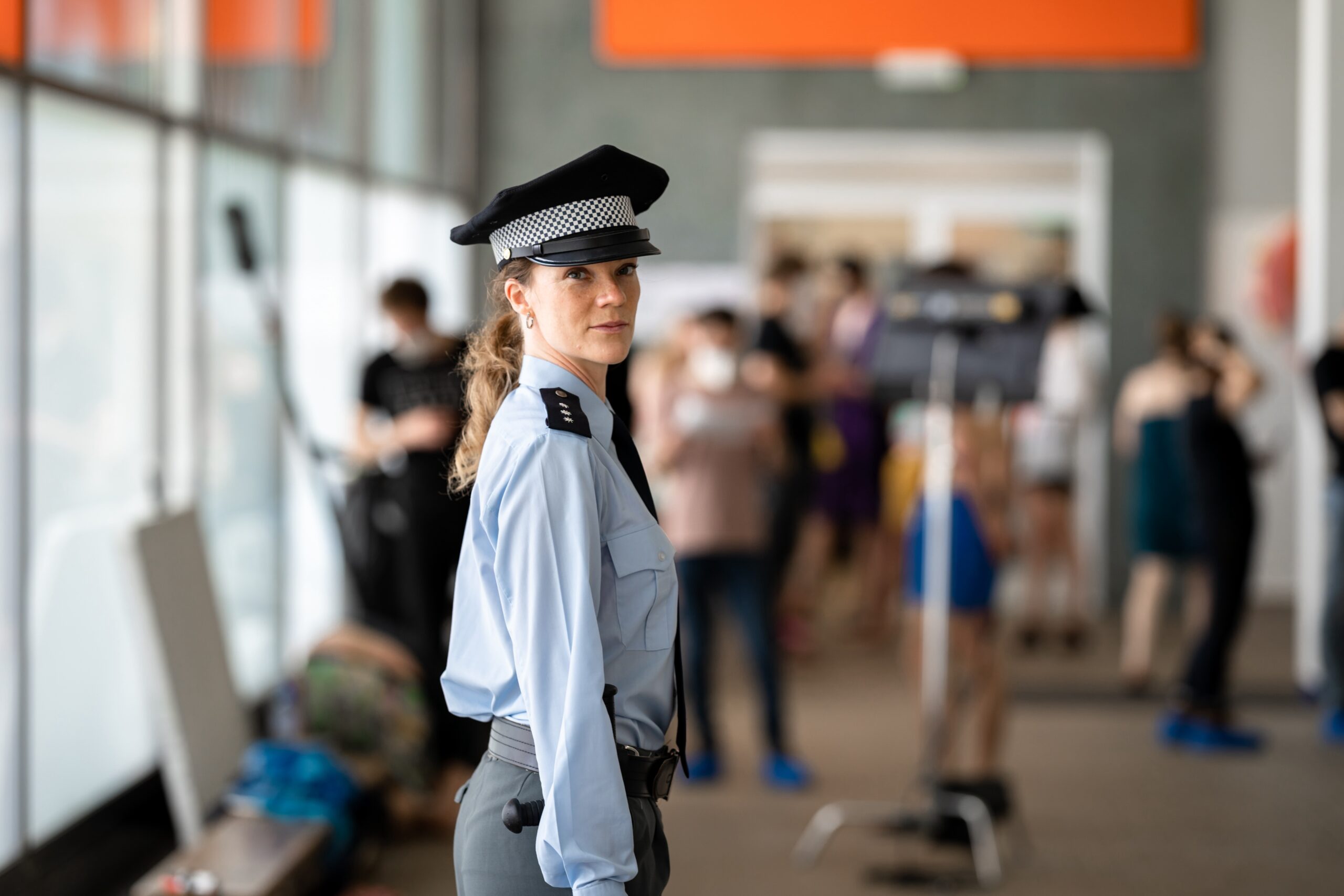 female police officer in uniform on duty during a public event.